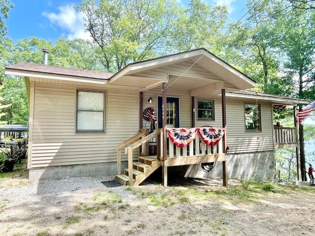 back of house featuring covered porch