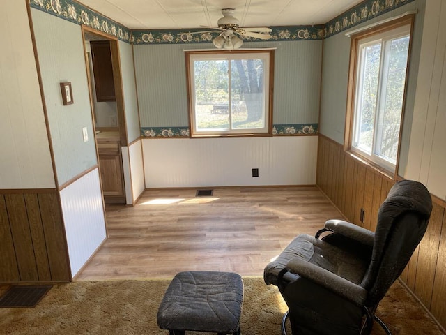 sitting room featuring light hardwood / wood-style flooring and ceiling fan