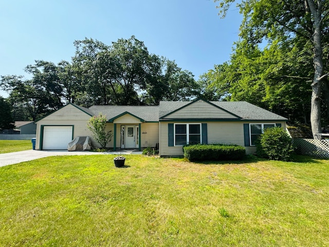 single story home featuring a garage and a front lawn