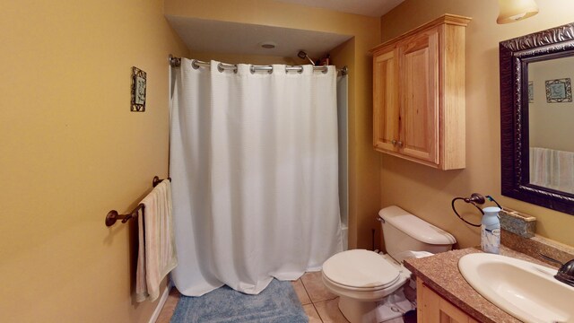 bathroom with vanity, tile patterned flooring, and toilet