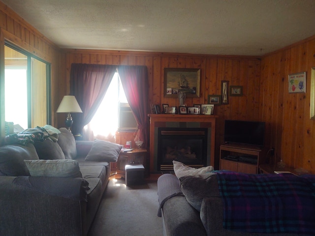 living room with carpet floors and wood walls