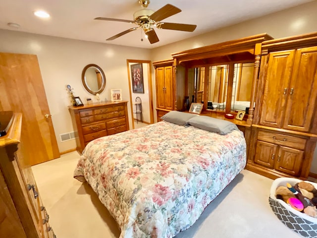 bedroom with light colored carpet and ceiling fan