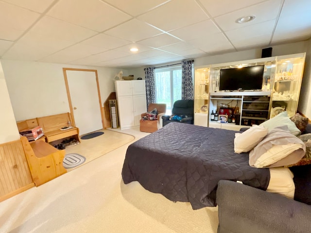 carpeted bedroom with a paneled ceiling