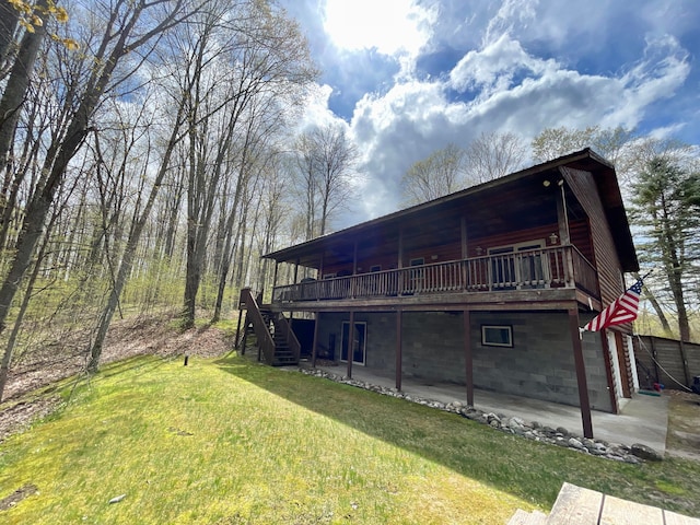 rear view of house with a patio area and a lawn