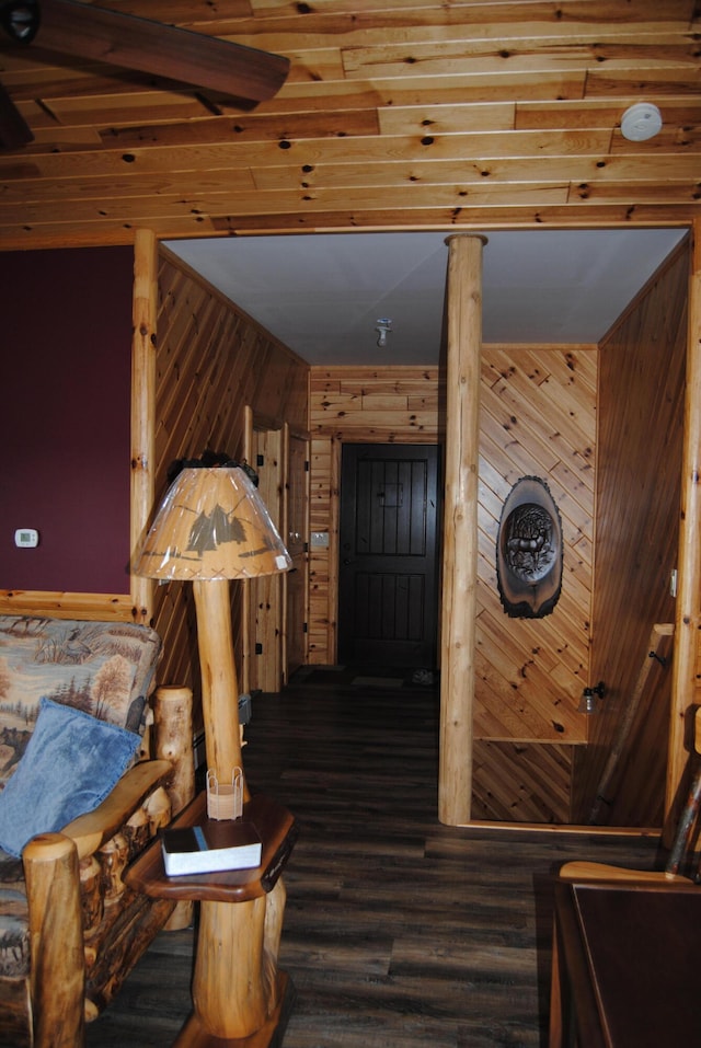 bedroom featuring hardwood / wood-style flooring and wooden walls