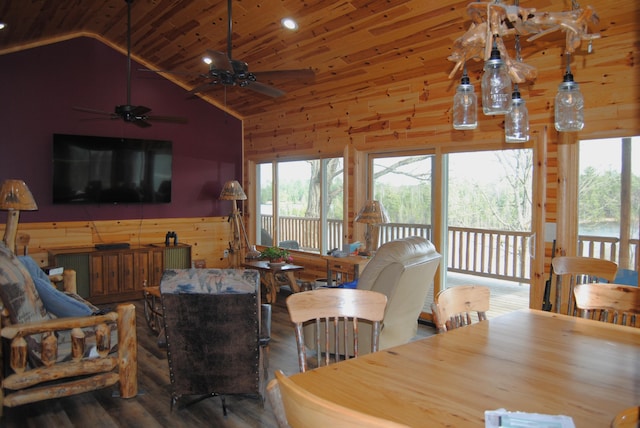 living room with wood walls, a healthy amount of sunlight, ceiling fan, and hardwood / wood-style flooring