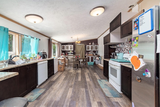 kitchen with sink, ornamental molding, white appliances, and dark hardwood / wood-style floors