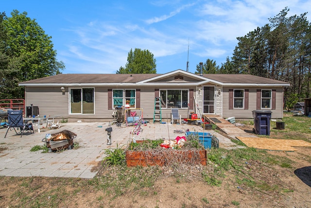 exterior space with an outdoor fire pit, central AC unit, and a patio