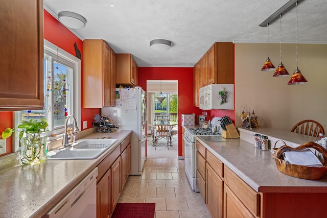 kitchen with white appliances, pendant lighting, a textured ceiling, light tile floors, and sink