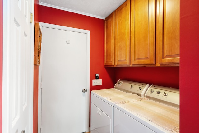 laundry area featuring cabinets, a textured ceiling, and washing machine and dryer