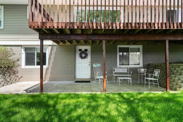 doorway to property featuring a yard and a patio