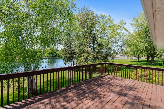 deck with a lawn and a water view