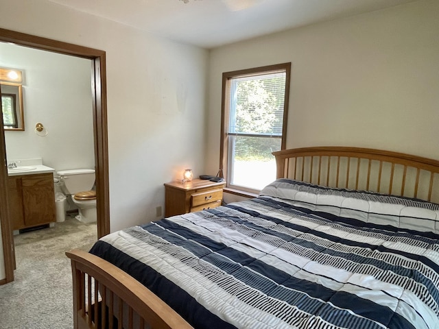 carpeted bedroom featuring ensuite bath