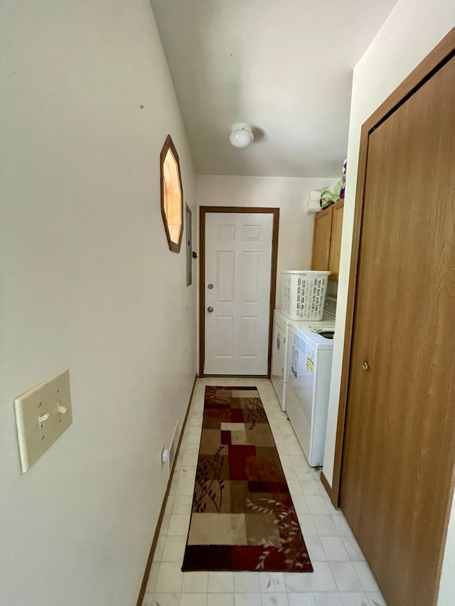 clothes washing area featuring cabinets, electric panel, and separate washer and dryer