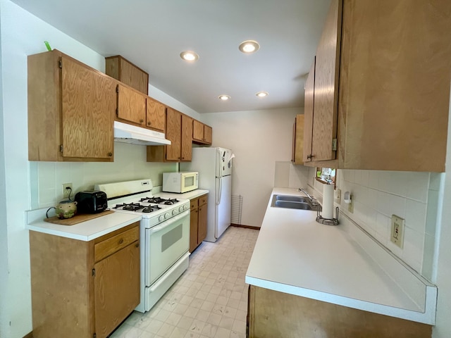 kitchen with sink, white appliances, and backsplash