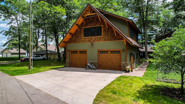 view of side of property featuring a garage and a lawn