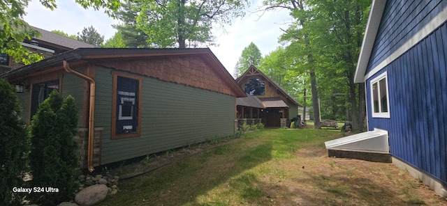 view of home's exterior with a yard