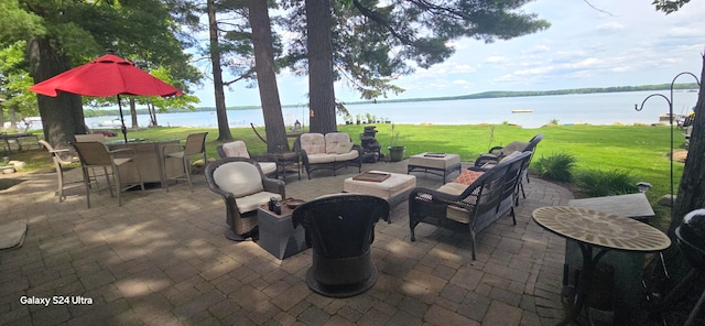 view of patio with an outdoor hangout area and a water view