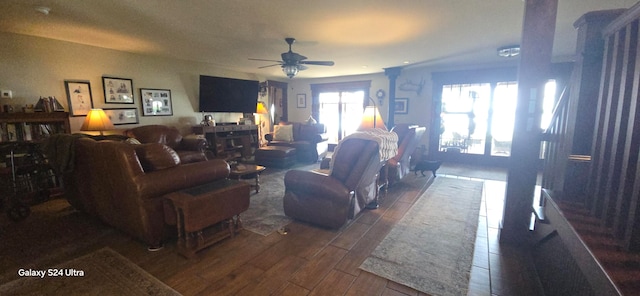 living room with dark hardwood / wood-style floors and ceiling fan