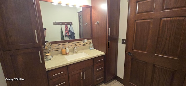 bathroom with vanity, backsplash, and tile patterned flooring