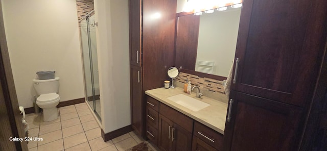 bathroom featuring tasteful backsplash, toilet, tile patterned floors, walk in shower, and vanity