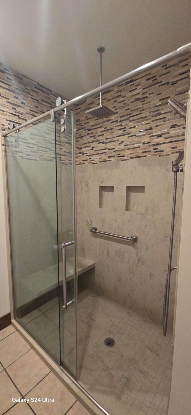 bathroom with walk in shower and tile patterned floors