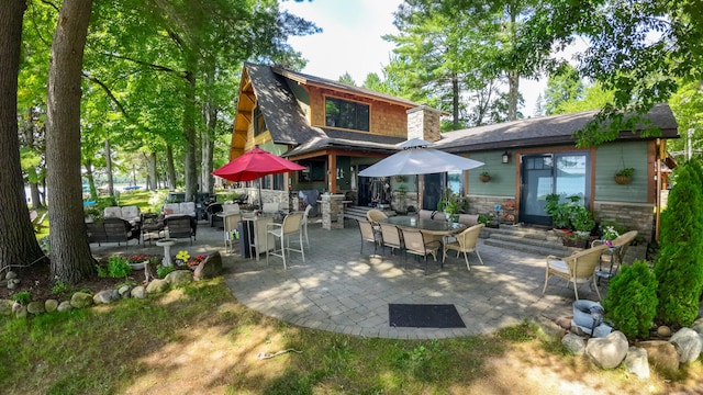 back of house with an outdoor hangout area and a patio area