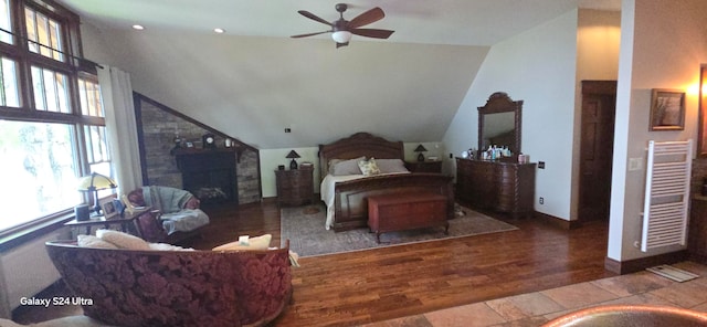 bedroom featuring vaulted ceiling, wood-type flooring, radiator heating unit, and ceiling fan