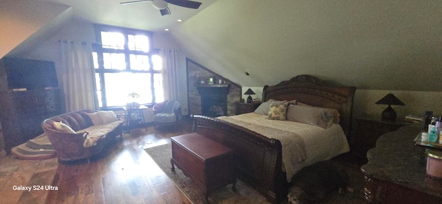 bedroom featuring vaulted ceiling, ceiling fan, multiple windows, and dark hardwood / wood-style flooring