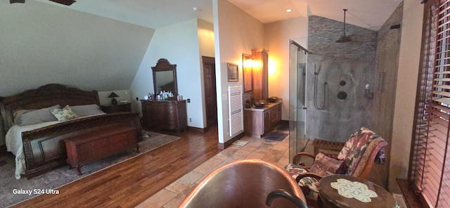 bedroom featuring hardwood / wood-style flooring and vaulted ceiling