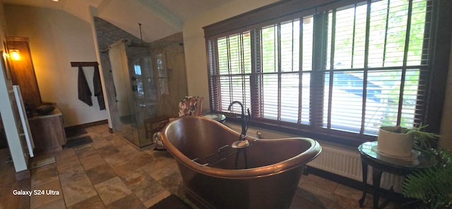 bathroom with a healthy amount of sunlight, lofted ceiling, and shower with separate bathtub