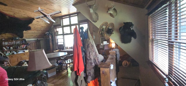 bedroom featuring wood walls, wooden ceiling, lofted ceiling, and hardwood / wood-style floors