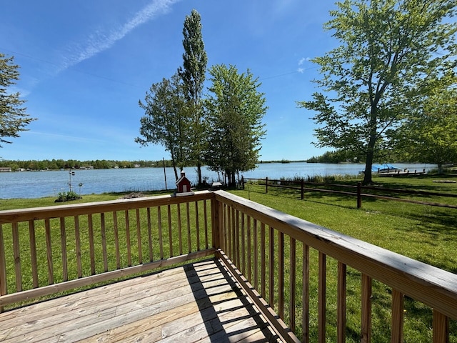 deck featuring a lawn and a water view