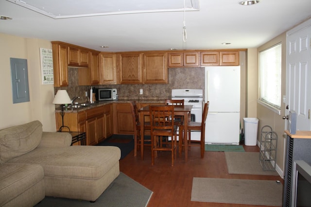 kitchen with sink, dark wood-type flooring, tasteful backsplash, electric panel, and white appliances