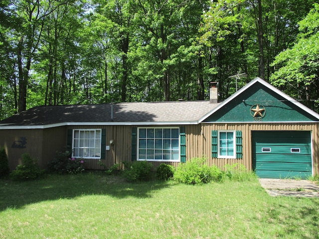 single story home featuring a front yard and a garage