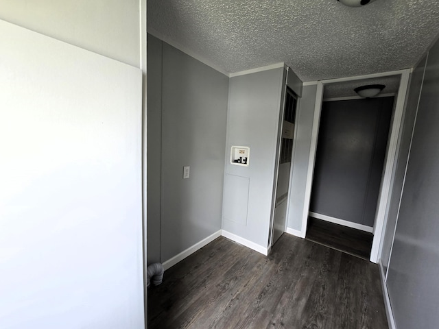 corridor with dark hardwood / wood-style flooring and a textured ceiling