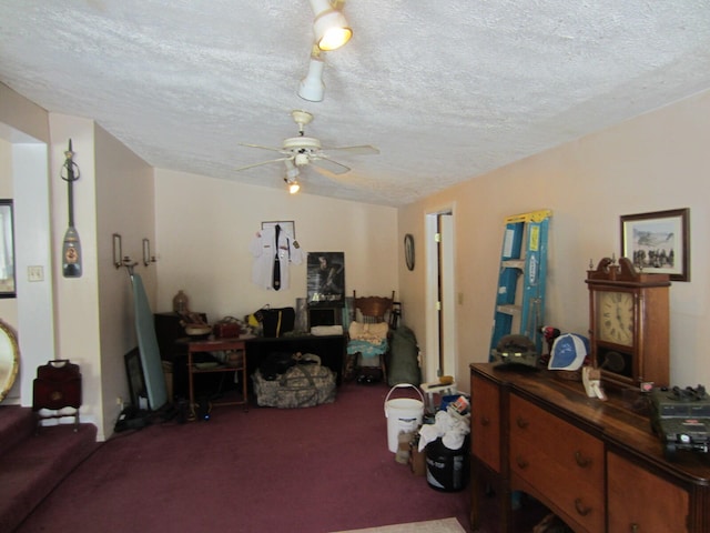 carpeted living room with ceiling fan and a textured ceiling