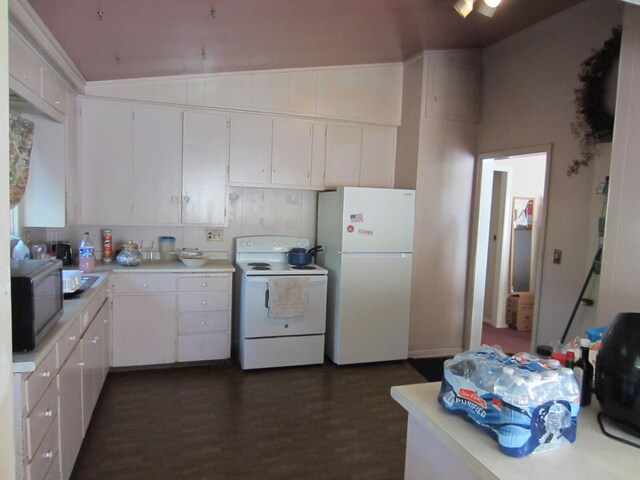 kitchen with vaulted ceiling, white cabinetry, white appliances, and dark hardwood / wood-style floors