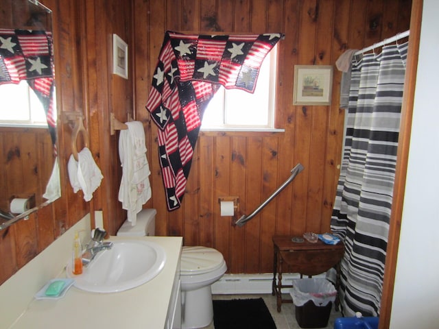 bathroom featuring wooden walls, plenty of natural light, toilet, and large vanity