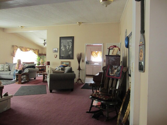 living room featuring a textured ceiling, ceiling fan, vaulted ceiling with beams, and carpet floors