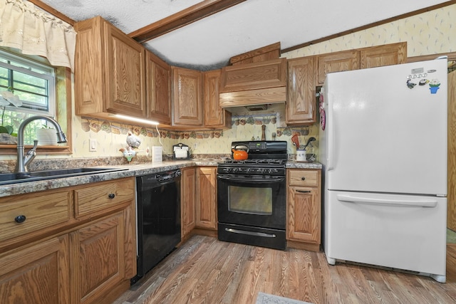 kitchen featuring black appliances, wood-type flooring, sink, and vaulted ceiling