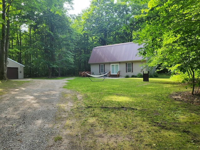 view of front of home featuring an outbuilding, a garage, and a front yard