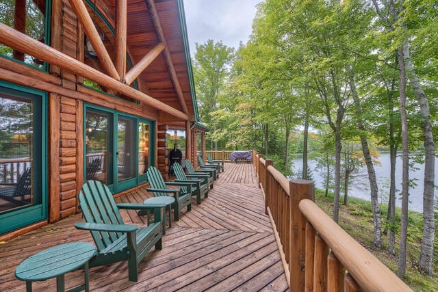 wooden terrace featuring a water view