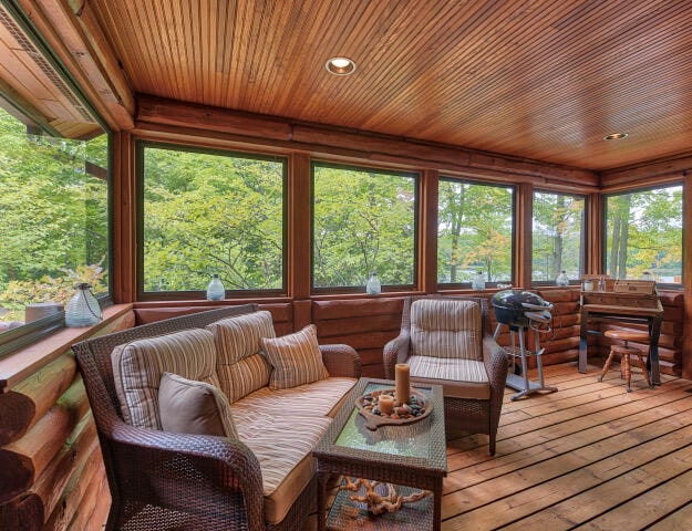 sunroom / solarium featuring wooden ceiling