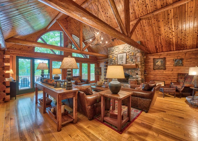 living room featuring beamed ceiling, a notable chandelier, high vaulted ceiling, hardwood / wood-style flooring, and wooden ceiling