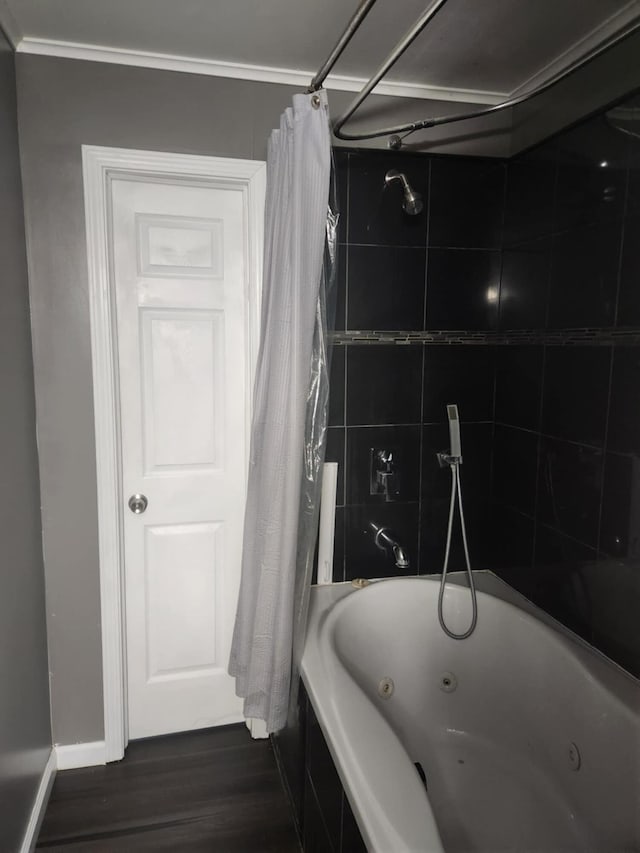 bathroom with shower / bath combo with shower curtain, hardwood / wood-style floors, and crown molding