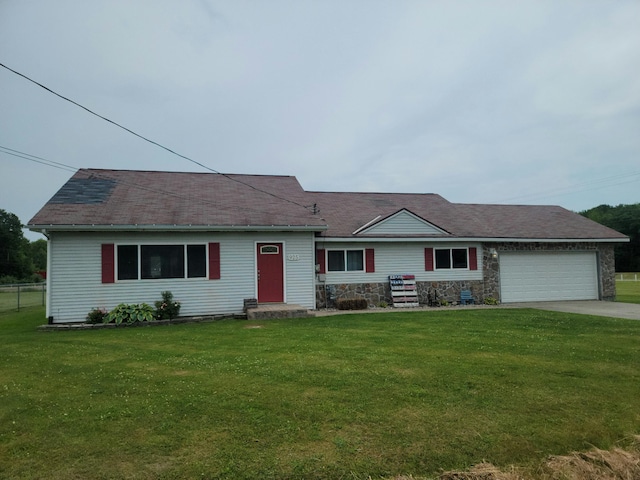 single story home with a garage and a front yard