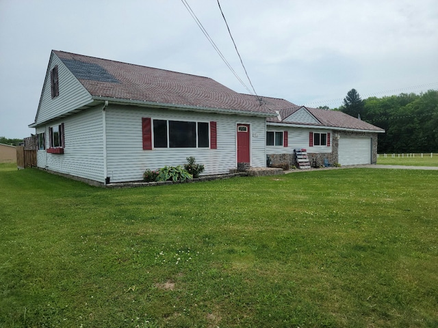 ranch-style house with a garage and a front lawn