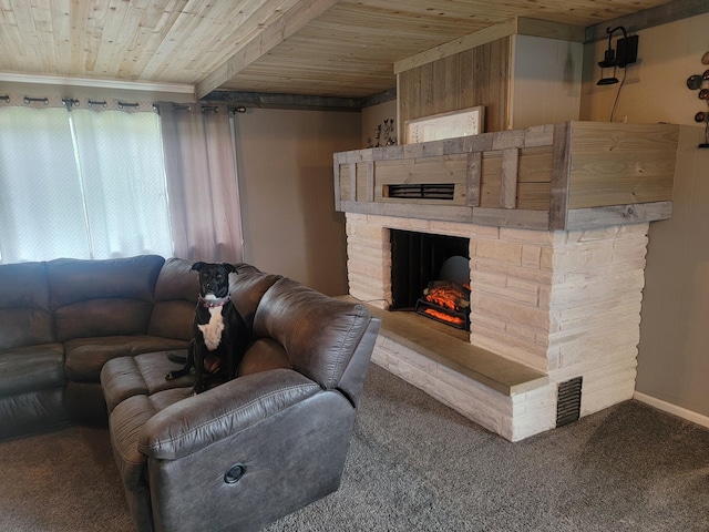 carpeted living room featuring wooden ceiling, ornamental molding, and a stone fireplace