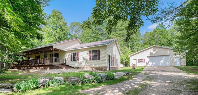 view of front of house with a garage, a porch, and an outdoor structure